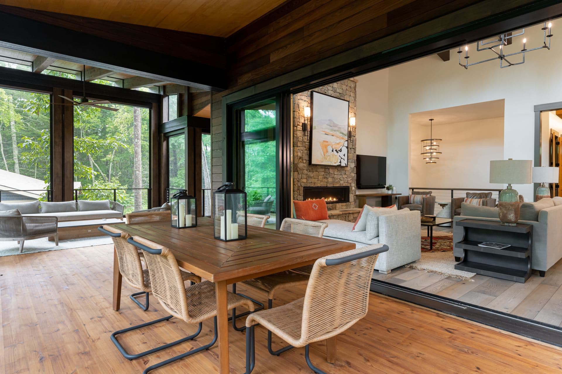 Dining and living area opening to the wooded mountain view