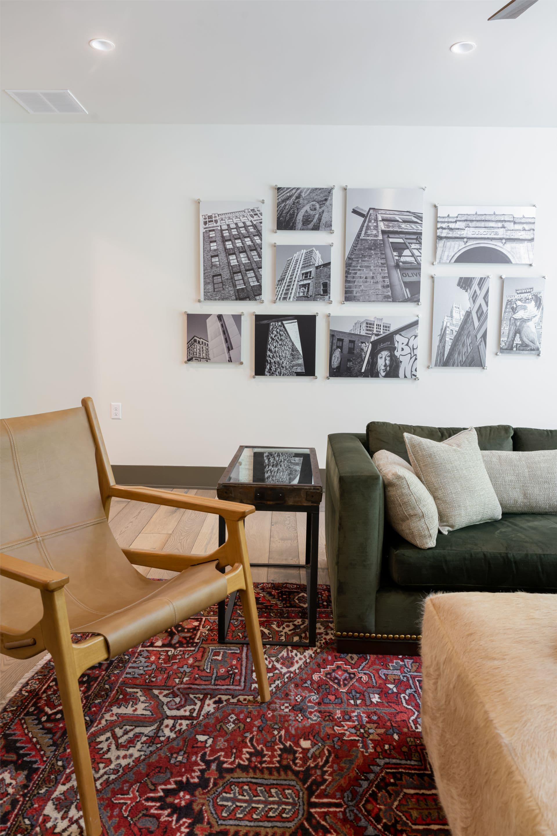 Family sitting area with a gallery wall, green sofa and patterned rug