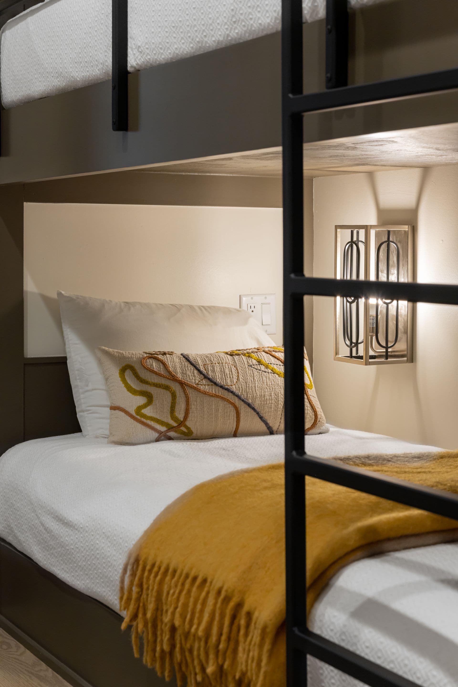 Close view of a cozy bunk with mustard-colored bedding
