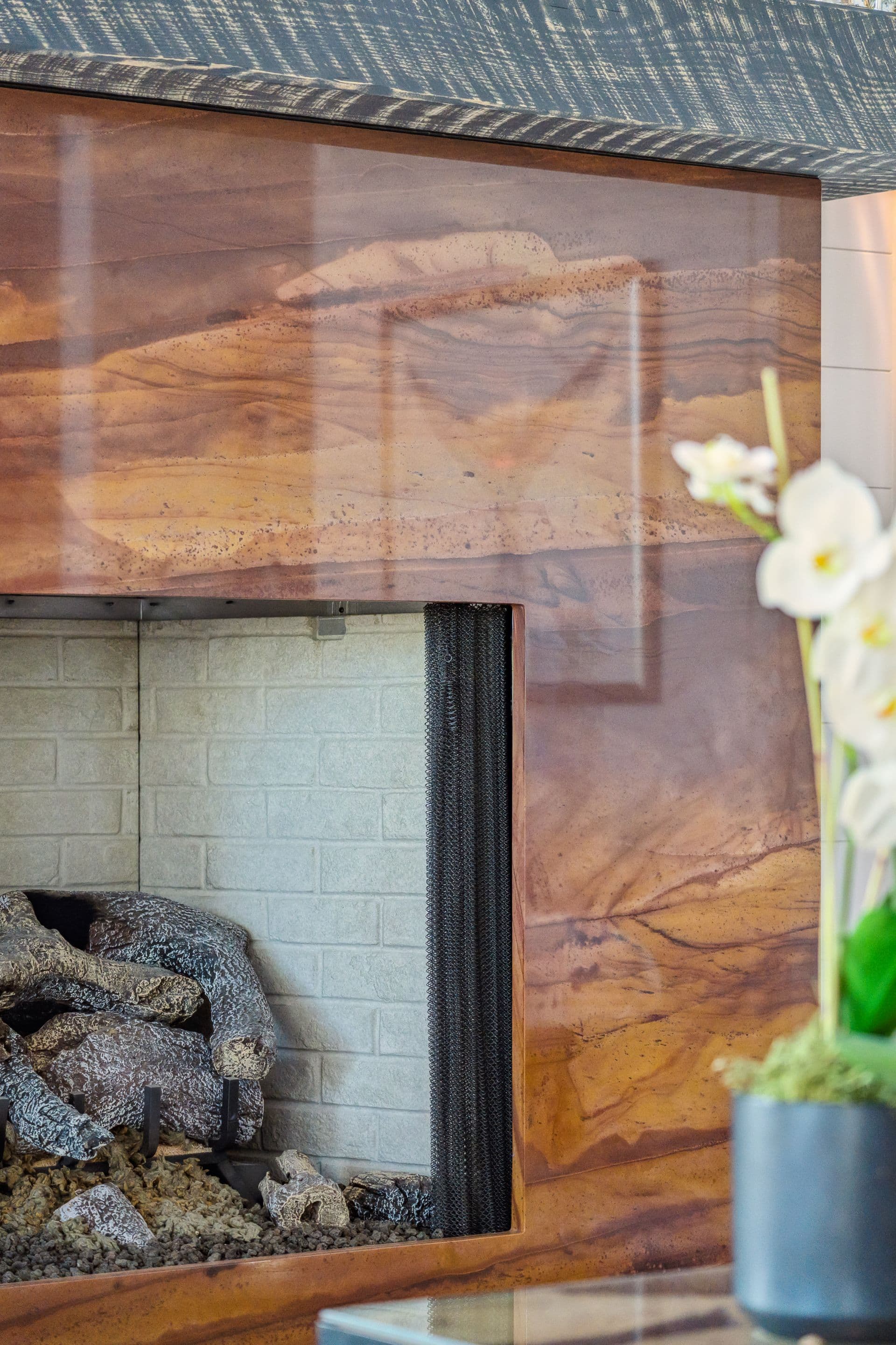 Copper fireplace surround beside a window