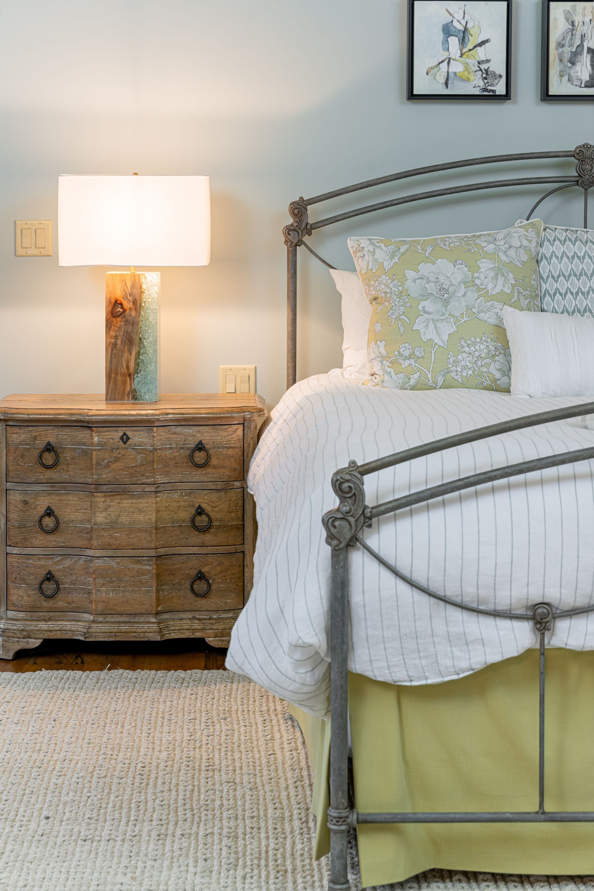 Quiet guest bedroom with a vintage dresser and soft green accents