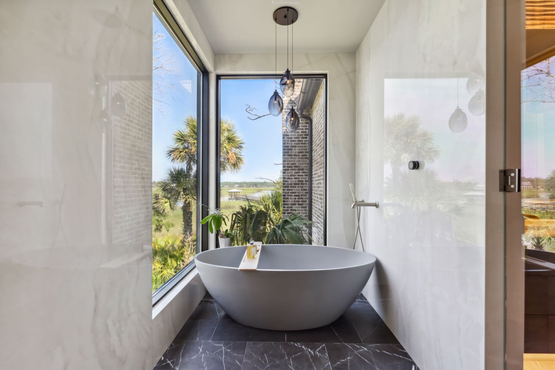 A sunlit bathroom with a sculptural soaking tub